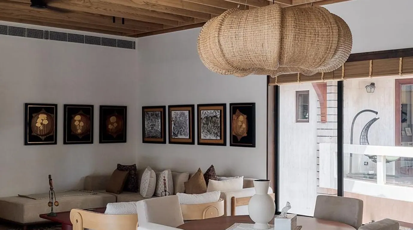 KSHITIJ lounge with framed artwork and woven pendant lights