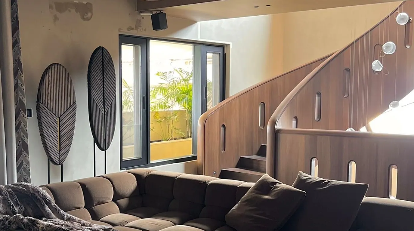 SHANTI stair hall with curved timber balustrade